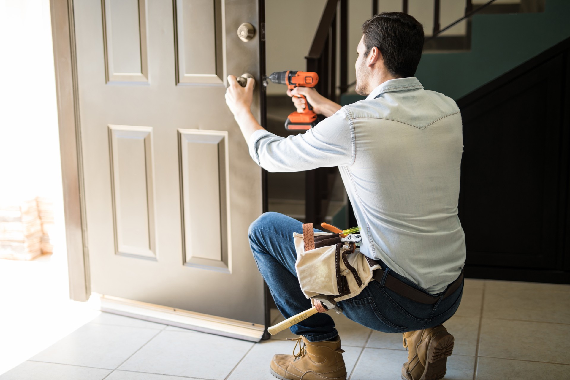 Young man fixing a door lock